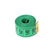 twisted green measuring tape on a white background. Tailor item photo