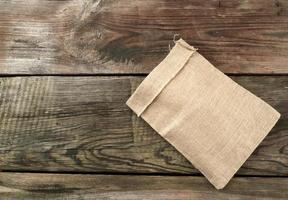 empty canvas gray bag on a wooden background from boards photo
