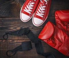 red leather boxing gloves and textile sneakers photo