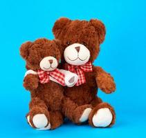 brown teddy bear with rewound white bandage paw photo