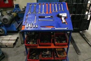 Professional car metal chrome mechanic set of various working construction tools organized on a board table. Workshop wrenches, hammer, clamps, screwdrivers. Repair instruments concept. photo