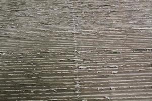 Paper grey recycled cardboard background. Natural corrugated carton sheet. Craft cardboard texture with horizontal stripe lines. Backdrop nature ecology pattern. photo
