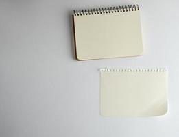 open spiral notepad with empty white sheets photo