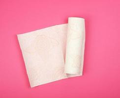 twisted roll of white soft paper napkins for face and hands photo