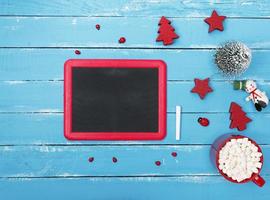 chalkboard in a red frame on a blue wooden background photo