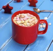 mug with hot chocolate and small pieces of marshmallow photo
