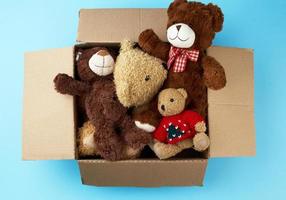 brown cardboard box with various teddy bears photo