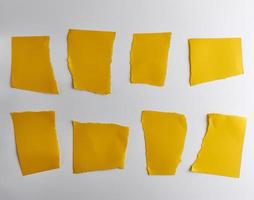 empty torn pieces of yellow paper on a white background photo