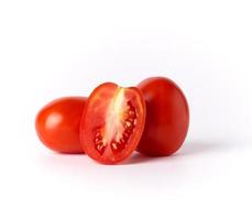 ripe red whole tomatoes and pieces on a white background,