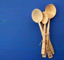 set of wooden vintage spoons tied with brown rope photo