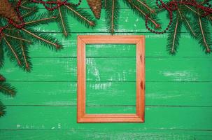 Wooden photo frame on a green  background