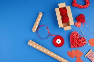 brown kraft paper, packed gift box, red ribbon, red heart, set of items for making gifts with your own hands. Gift wrapping photo