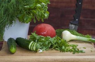 Cucumber, tomato, onion and parsley photo