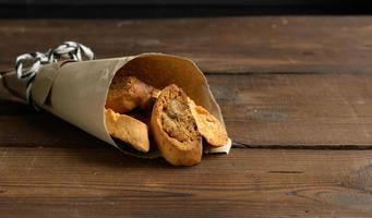 pieces of baked italian christmas biscotti cookies, wooden background photo