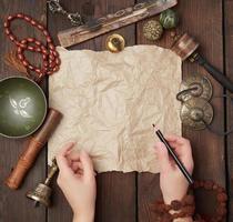 tibetan religious objects for meditation and alternative medicine, empty brown sheet of paper photo