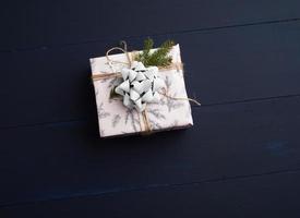 gift wrapped in colored paper on a blue wooden background photo