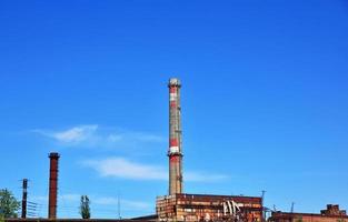 Brick pipe factory against a clear sky photo