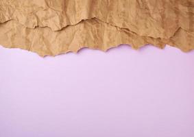 abstract lilac background with brown torn paper elements photo