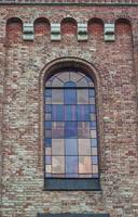 glass window with stained-glass windows on the top of the church photo