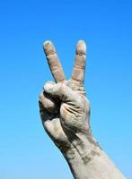 Male hand is raised up and demonstrates a victory gesture photo