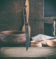 old wooden cutting board and knife photo