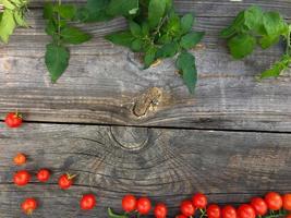 Red cherry tomatoes on a wooden background photo
