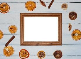 Empty wooden photo frame on white wooden surface