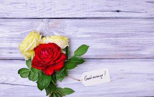 bouquet of blossoming roses with a paper tag photo