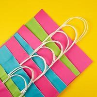multi-colored paper shopping bags with white handles photo