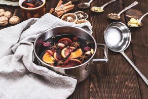 mulled wine in a pan with an iron scoop photo