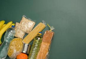 various products, fruits, pasta, sunflower oil in a plastic bottle and preservation, top view. Donation concept photo