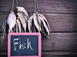 Dried fish hangs on a rope photo