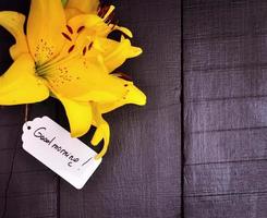 Yellow lily and a paper tag photo