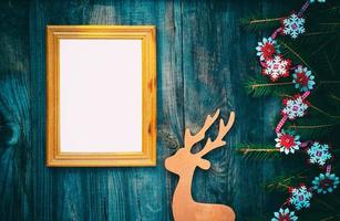 empty picture frame on a gray wooden surface with Christmas decorations photo