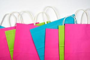 multi-colored paper shopping bags with white handles photo