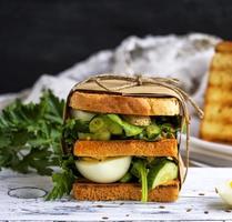 sandwich of French toast and lettuce leaves and boiled egg photo