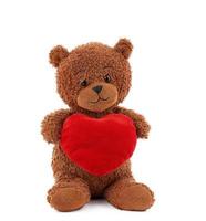 cute brown teddy bear holding a big red heart photo