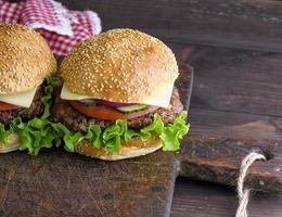 hamburger with a meat chop and a round bun with sesame photo