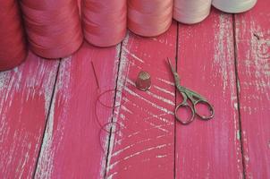 Thread, scissors and needle for sewing photo