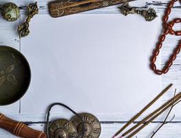 Copper singing bowl, prayer beads, prayer drum, stone balls and other Tibetan religious objects for meditation photo