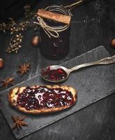 fried piece of white bread with raspberry jam photo