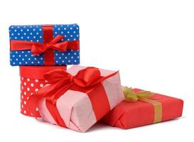 stack of boxes wrapped in paper and tied with a silk ribbon on a white background, celebration photo