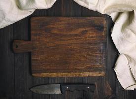 empty old brown wooden cutting board with handle photo