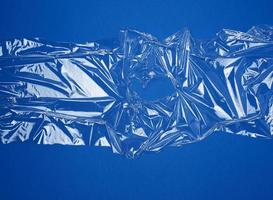 texture of a transparent stretching plastic film for packaging products on a blue background photo