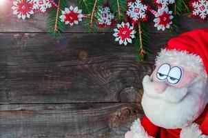 Sad Santa on a background of a wooden wall photo