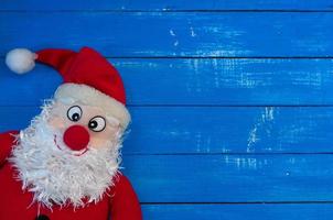 Christmas Santa Claus on a blue wooden background photo