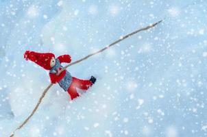 Wooden little toy in winter scene photo