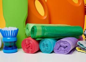 Stack of disposable plastic trash can bags on a yellow background photo