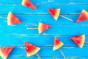 slices of ripe red watermelon on a wooden stick photo