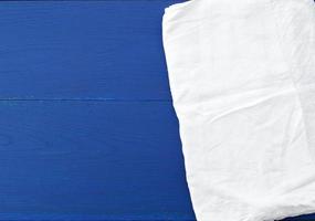 white kitchen textile towel folded on a blue wooden table from old boards photo